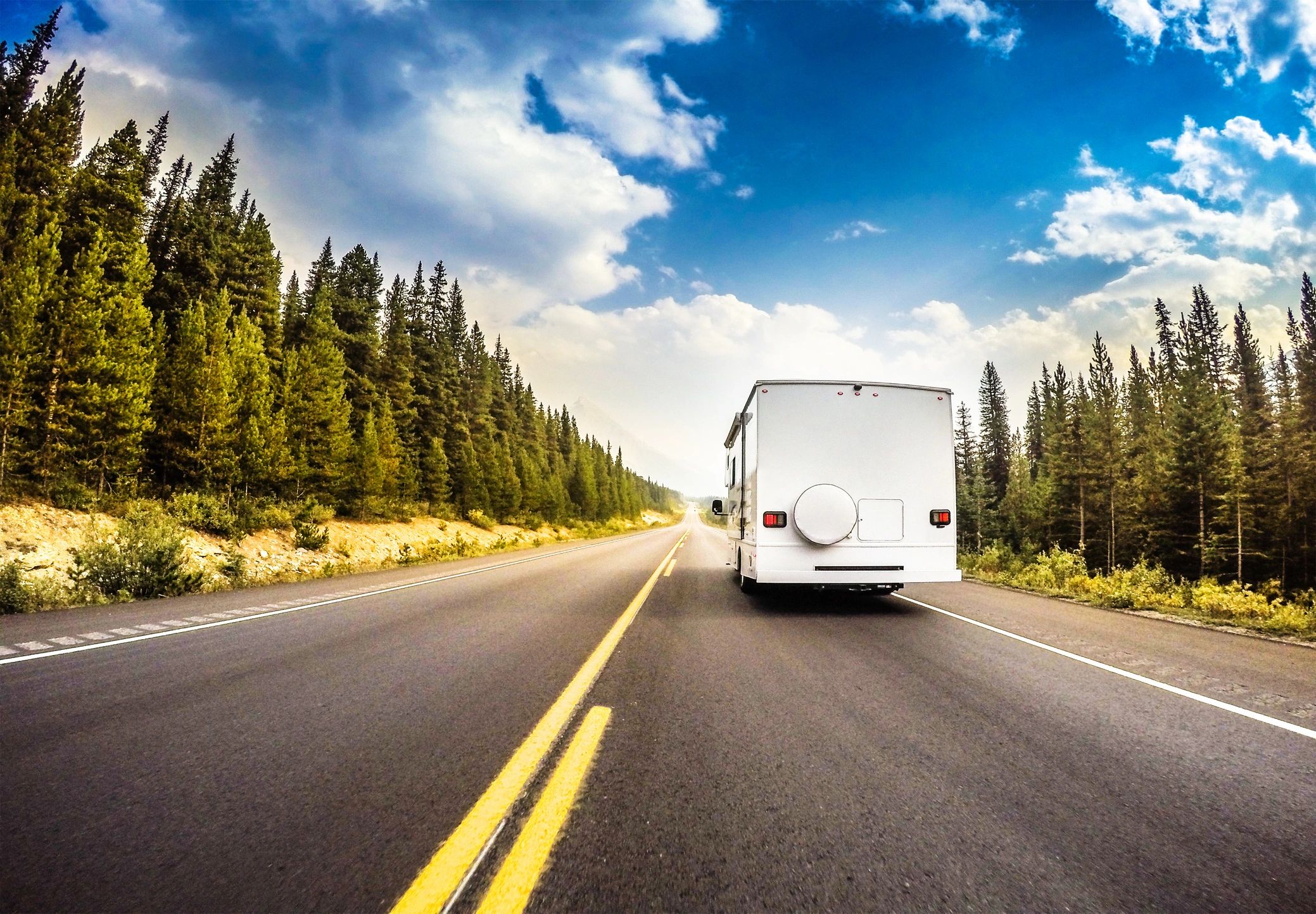 RV driving through a mountain road in a national park